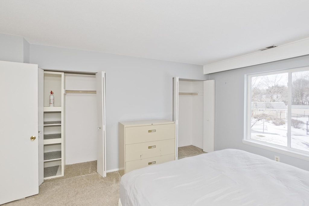 169 Nassau Drive, Unit 169 Springfield, MA 01129 - Photo 23 of 31 a bedroom with a bed and a window