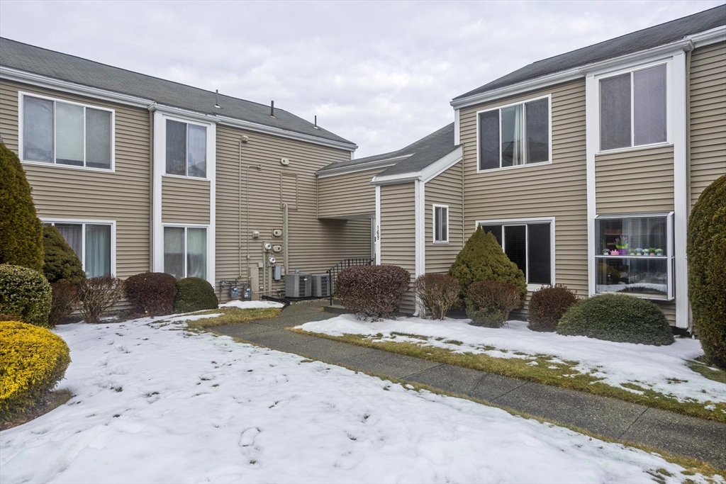 169 Nassau Drive, Unit 169 Springfield, MA 01129 - Photo 27 of 31 a view of a house with a yard in front of it
