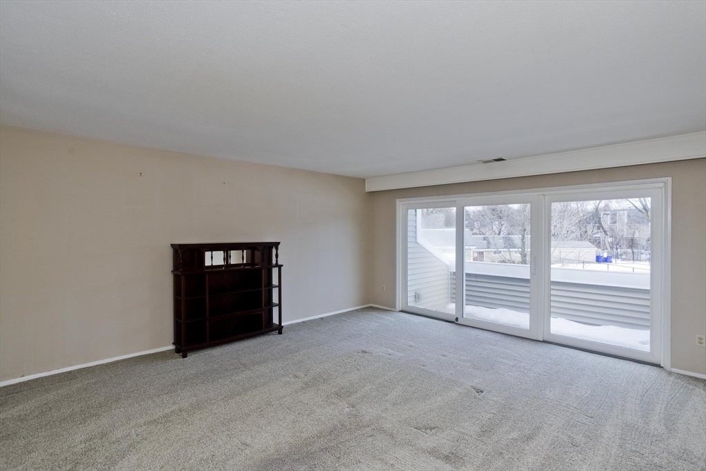 169 Nassau Drive, Unit 169 Springfield, MA 01129 - Photo 4 of 31 an empty room with windows