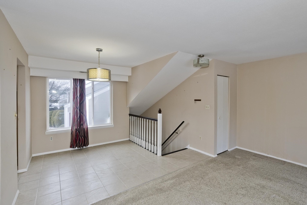 169 Nassau Drive, Unit 169 Springfield, MA 01129 - Photo 5 of 31 an empty room with staircase and door