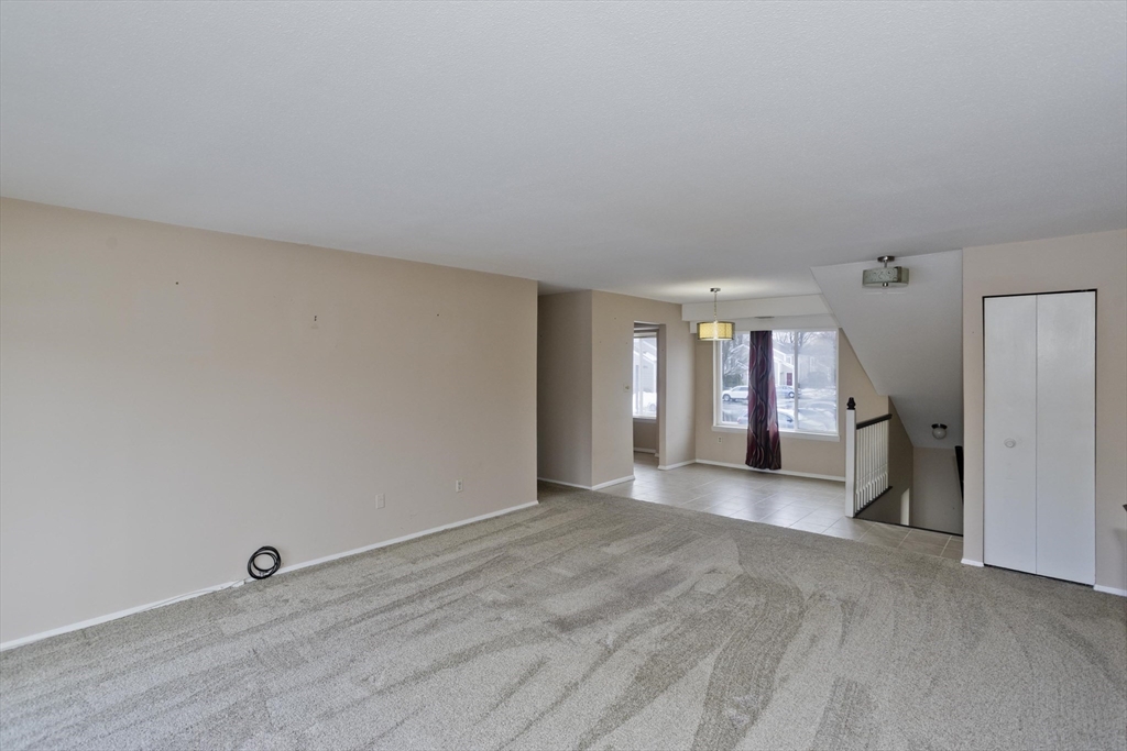 169 Nassau Drive, Unit 169 Springfield, MA 01129 - Photo 9 of 31 a view of a livingroom with wooden floor and window