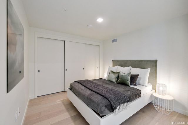 a bedroom with a large bed and a large window