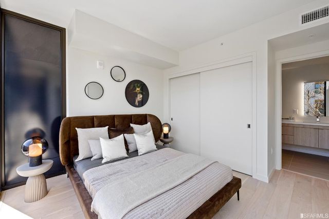 a bedroom with a large bed and a large window