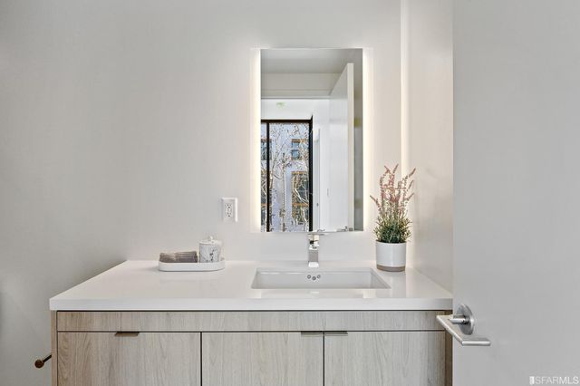 a bathroom with a double vanity sink toilet and shower