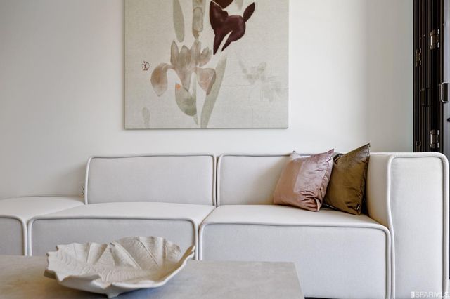 a bed with a white comforter and pillows