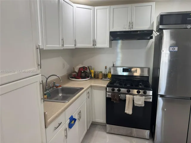 a kitchen with a stove and a refrigerator