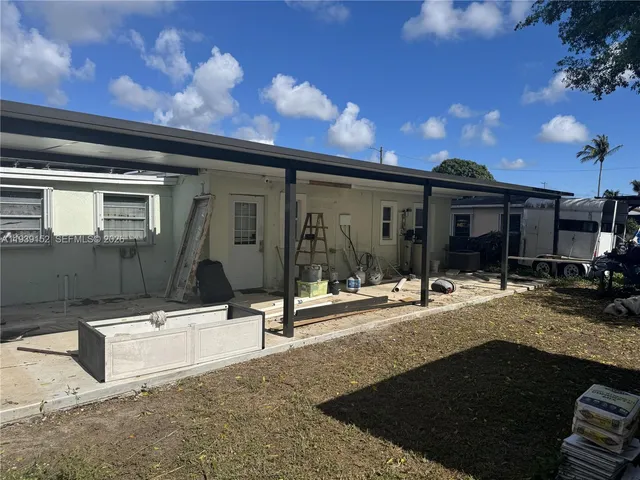 a view of a patio with table and chairs with wooden floor and fence