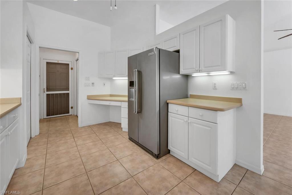 1946 Timberline Drive Naples, FL 34109 - Photo 11 of 19 a kitchen with a refrigerator sink and cabinets
