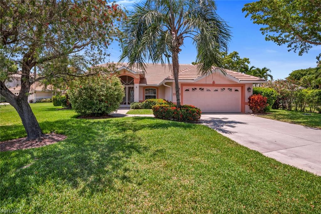 1946 Timberline Drive Naples, FL 34109 - Photo 2 of 19 a front view of a house with garden