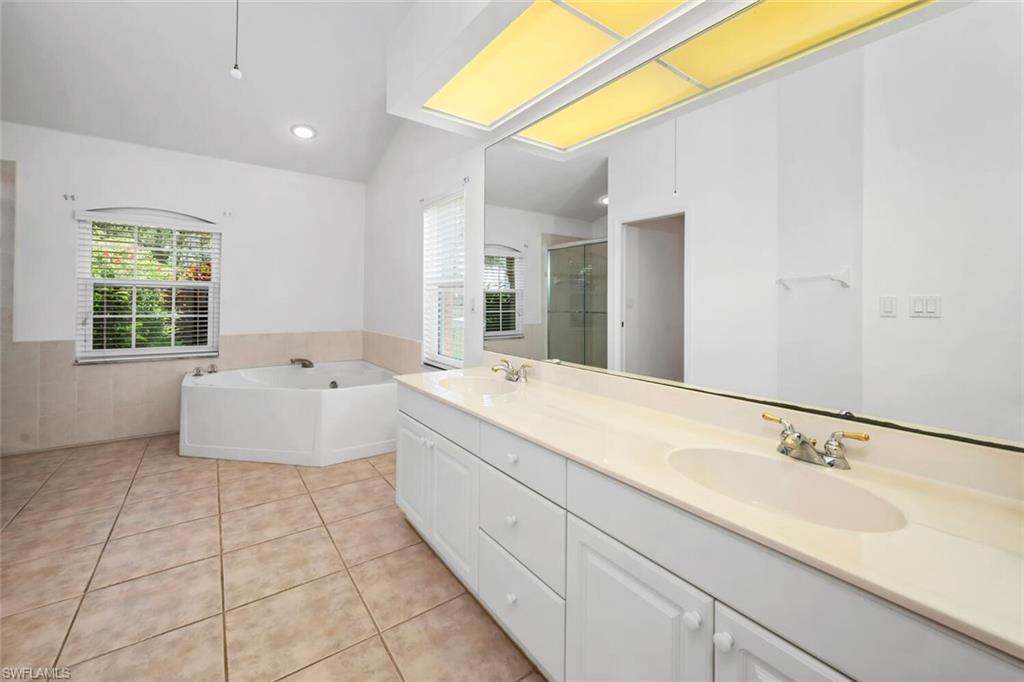 1946 Timberline Drive Naples, FL 34109 - Photo 7 of 19 a spacious bathroom with a bathtub sink and mirror