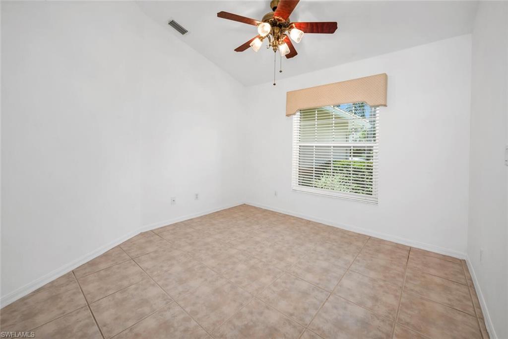 1946 Timberline Drive Naples, FL 34109 - Photo 8 of 19 an empty room with a window and a ceiling fan
