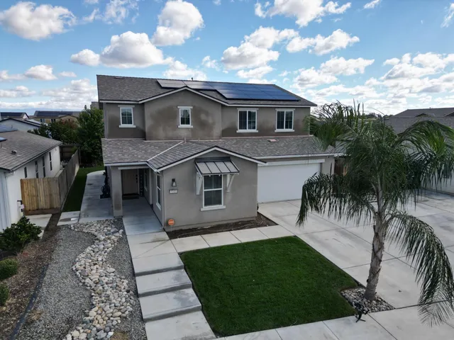 a aerial view of a house with a yard and furniture