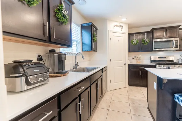a kitchen with stainless steel appliances granite countertop a sink stove and refrigerator