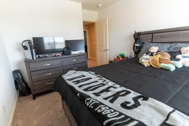 a bedroom with a bed and a chandelier
