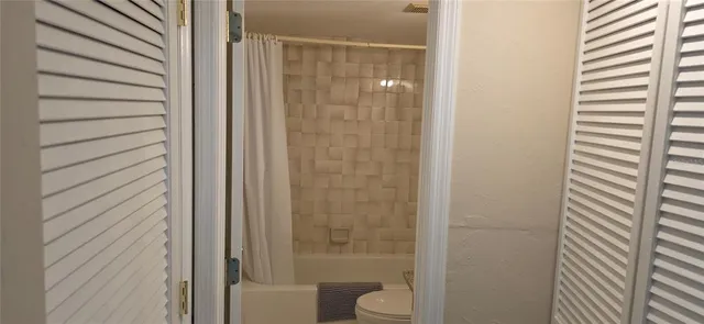 a bathroom with a shower and a toilet
