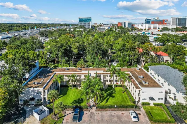 an aerial view of multiple houses with yard