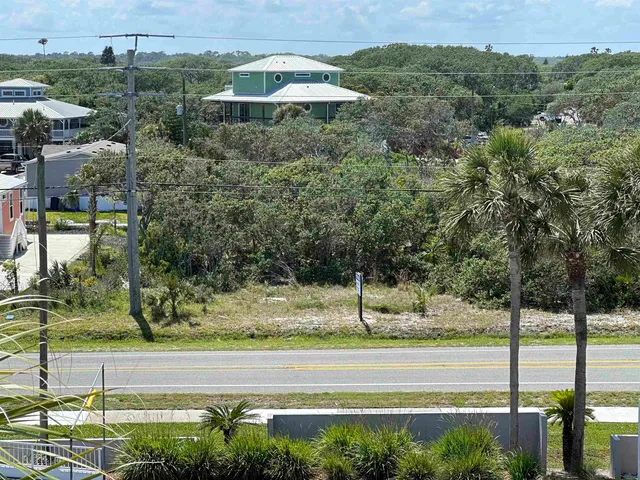a view of a swimming pool with a yard and plants
