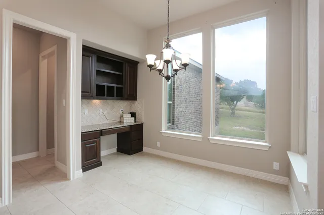 a very nice looking room with a large window and kitchen view