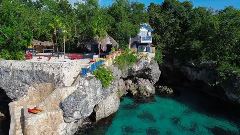 a view of a house with a yard and a fountain