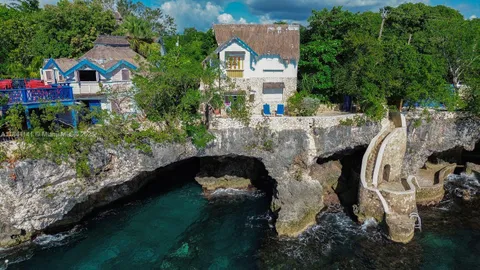 a bed with white sheets and a wooden floor