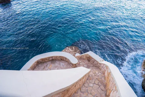 a view of a balcony dining area and chandelier