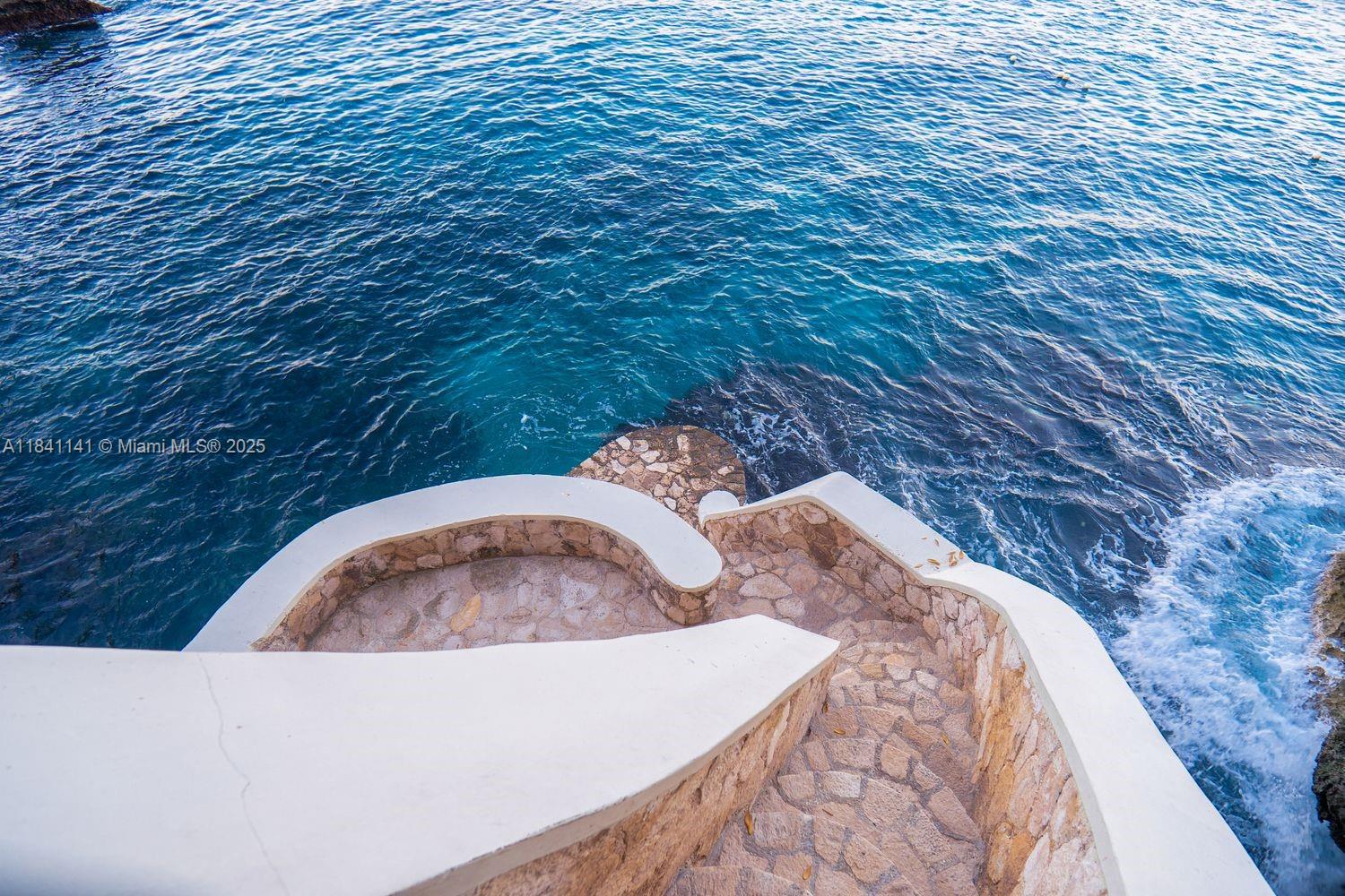 144 One Love Drive undefined, - 00000 - Photo 20 of 34 a bed with white sheets and a wooden floor