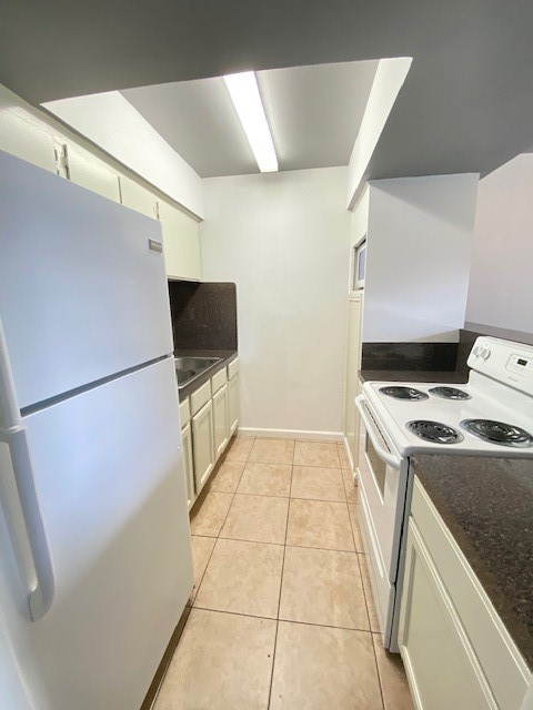 4701 Bell Street, Unit 10 Houston, TX 77023 - Photo 7 of 19 a kitchen with a stove top oven and cabinets