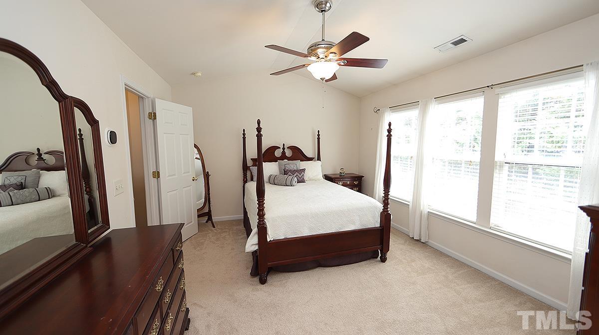 7225 Galon Glen Road Raleigh, NC 27613 - Photo 13 of 20 a bedroom with a large bed and a large window