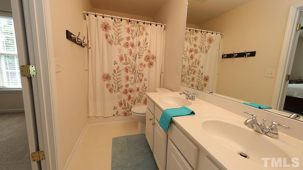 7225 Galon Glen Road Raleigh, NC 27613 - Photo 15 of 20 a bathroom with a sink and a mirror