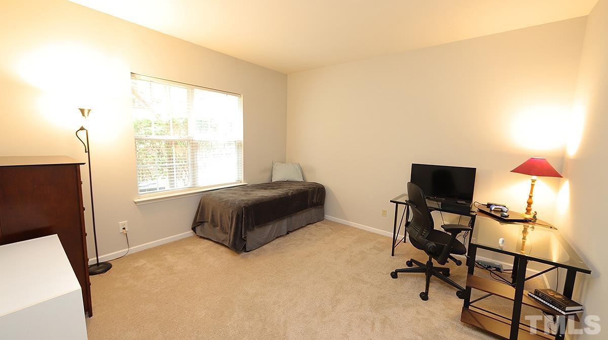 7225 Galon Glen Road Raleigh, NC 27613 - Photo 4 of 20 a bedroom with a bed and wooden floor