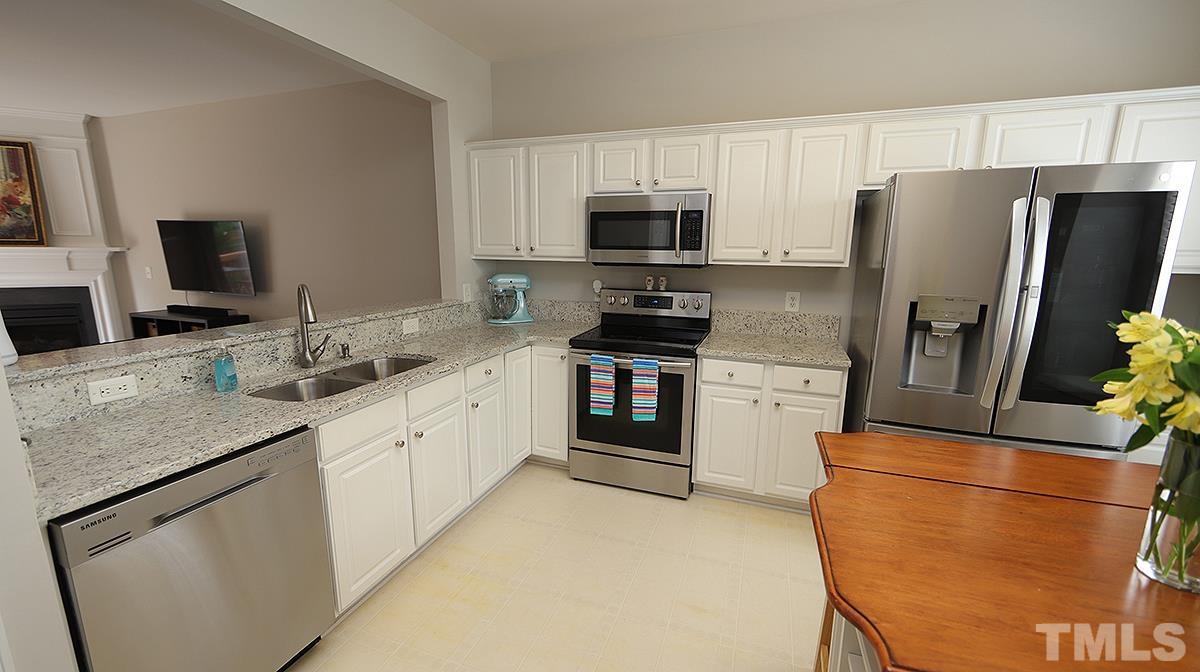 7225 Galon Glen Road Raleigh, NC 27613 - Photo 6 of 20 a kitchen with stainless steel appliances a refrigerator stove microwave and sink