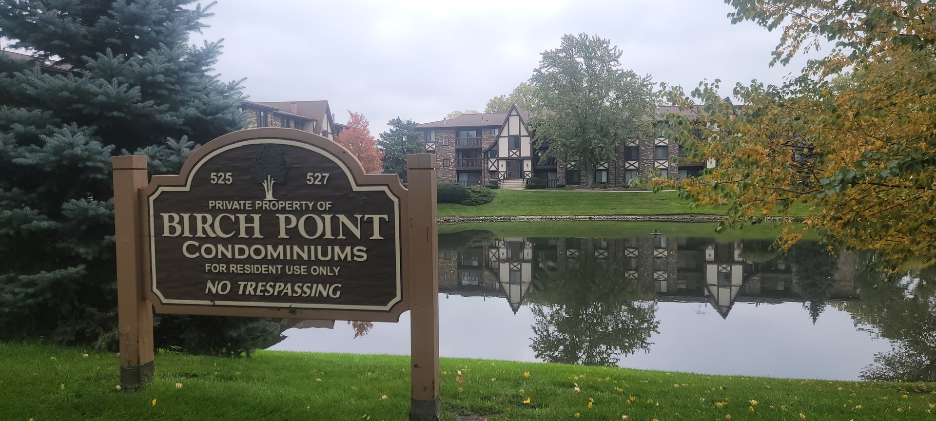 525 Cumnor Road, Unit 302 Westmont, IL 60559 - Photo 1 of 12 a view of a sign in front of a house with a garden