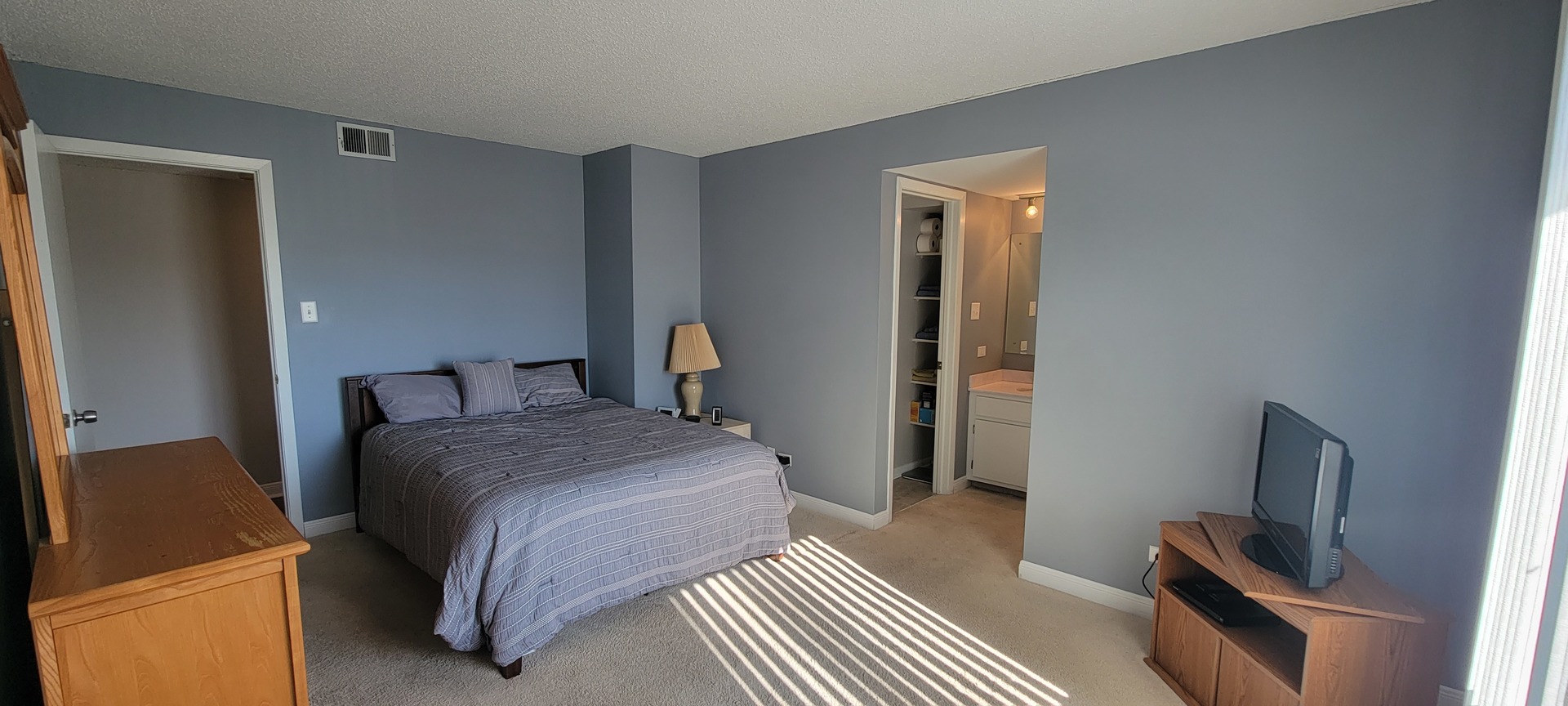 525 Cumnor Road, Unit 302 Westmont, IL 60559 - Photo 5 of 12 a bedroom with a bed and a flat screen tv