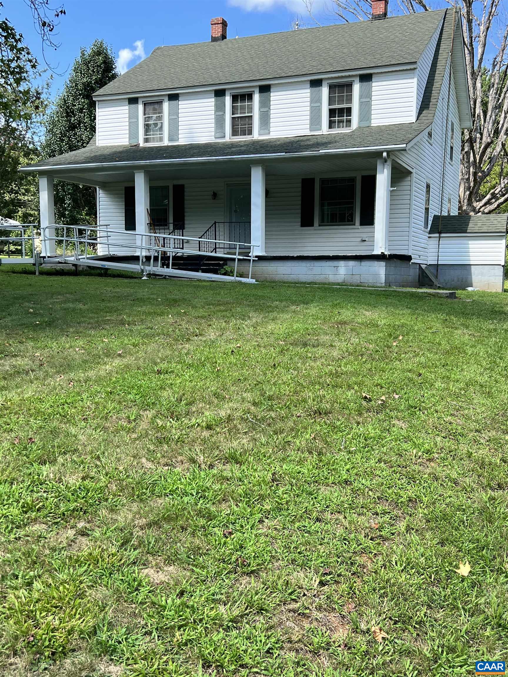 2857 Cedar Lane Road Kents Store, VA 23084 - Photo 1 of 36 a view of a white house with large windows and a yard with plants