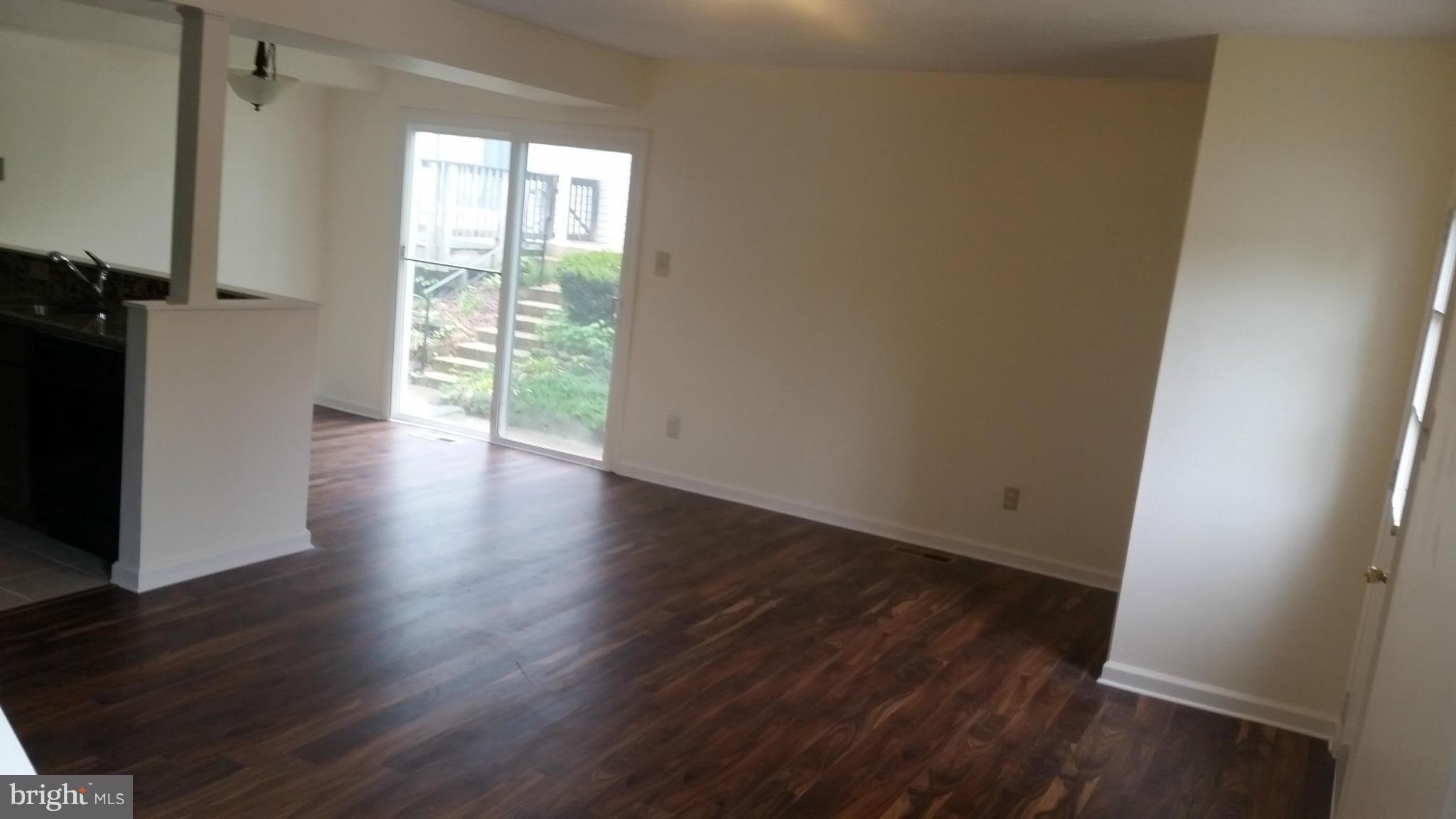 98 Ridgelawn Road, Unit A Reisterstown, MD 21136 - Photo 5 of 22 an empty room with wooden floor and windows