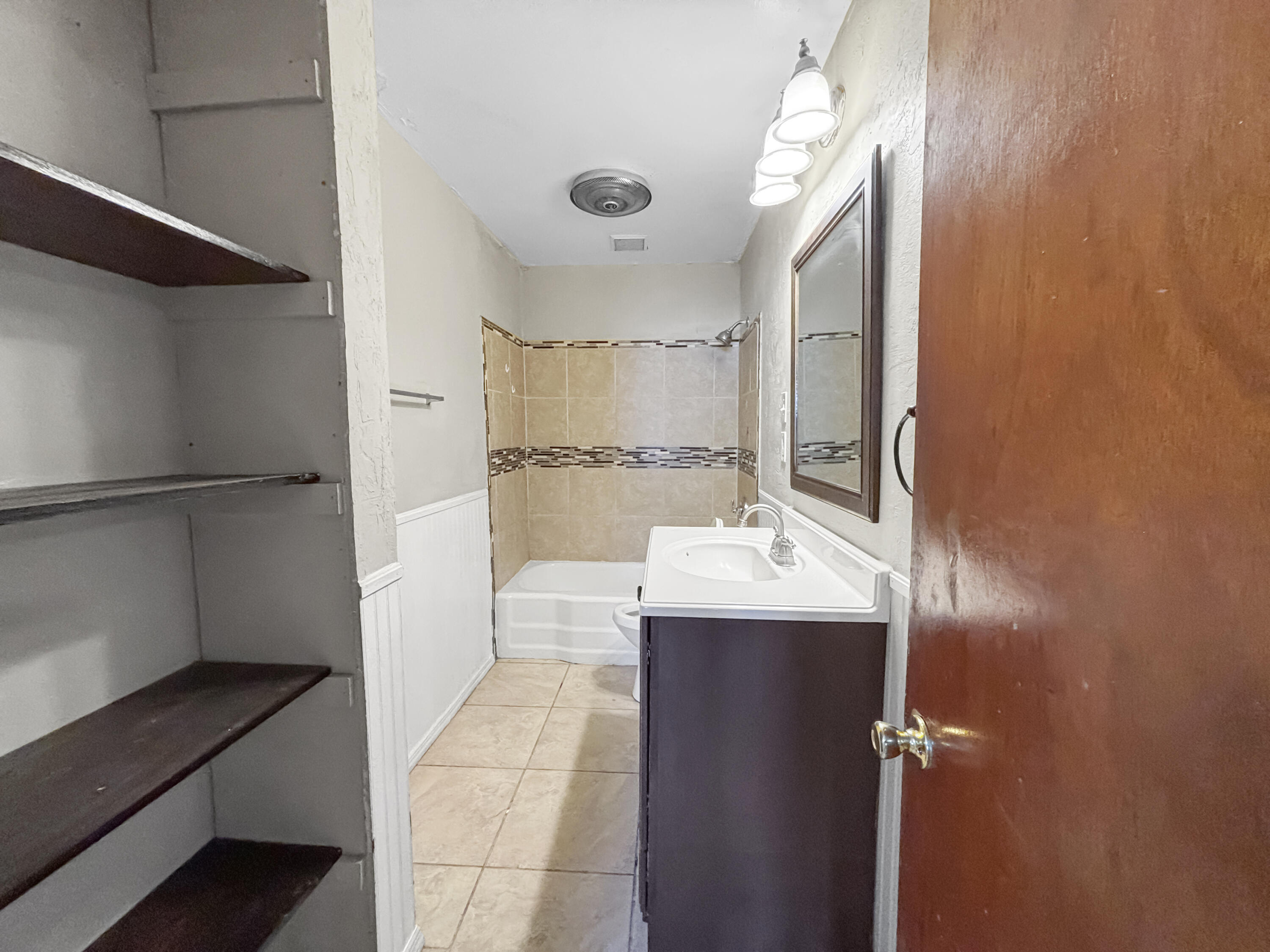 4411 45th Street Lubbock, TX 79414 - Photo 25 of 44 a view of bathroom with a sink and mirror