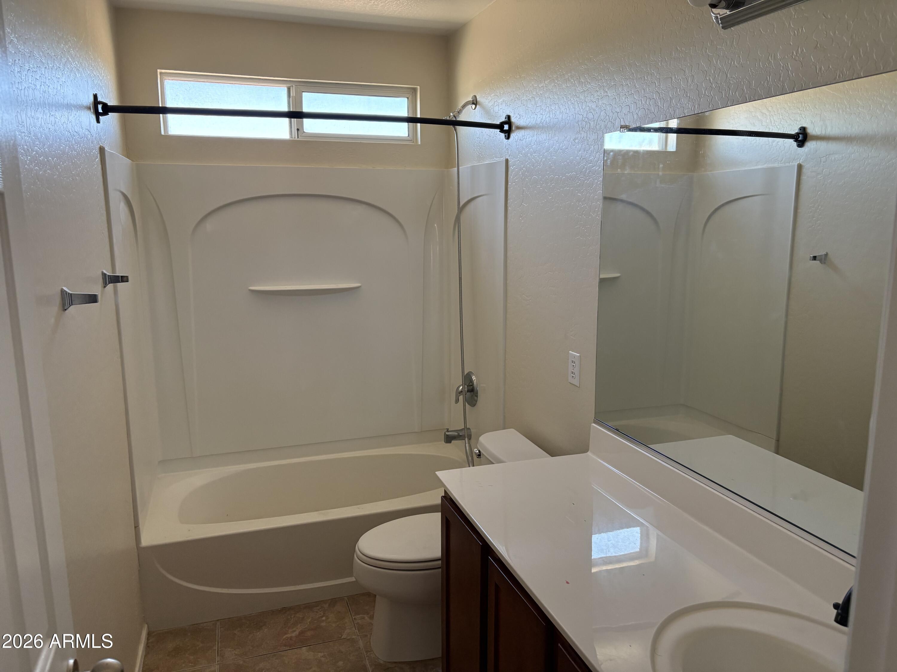 5222 East Silverbell Road San Tan Valley, AZ 85143 - Photo 12 of 16 a bathroom with a granite countertop bathtub shower sink vanity and toilet