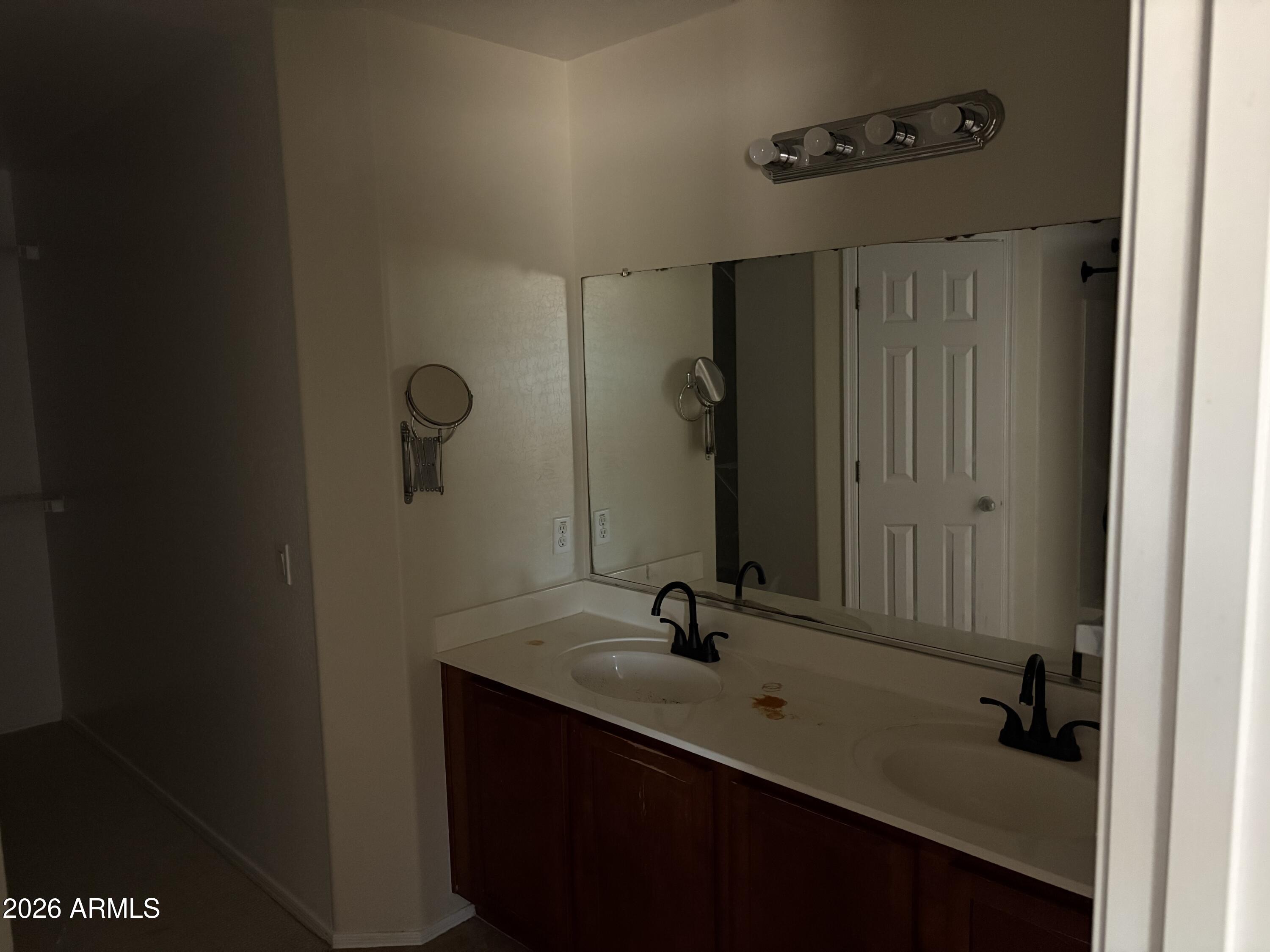 5222 East Silverbell Road San Tan Valley, AZ 85143 - Photo 14 of 16 a bathroom with a double vanity sink and a mirror
