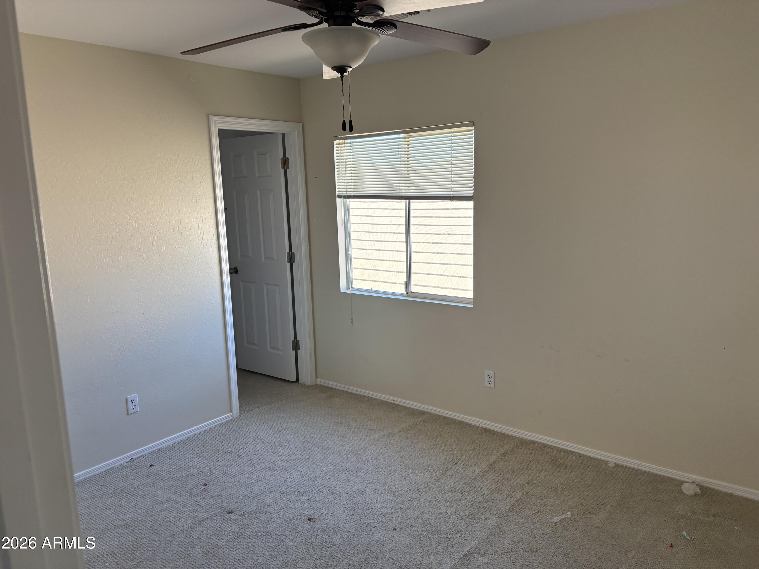 5222 East Silverbell Road San Tan Valley, AZ 85143 - Photo 15 of 16 an empty room with a window and a fan