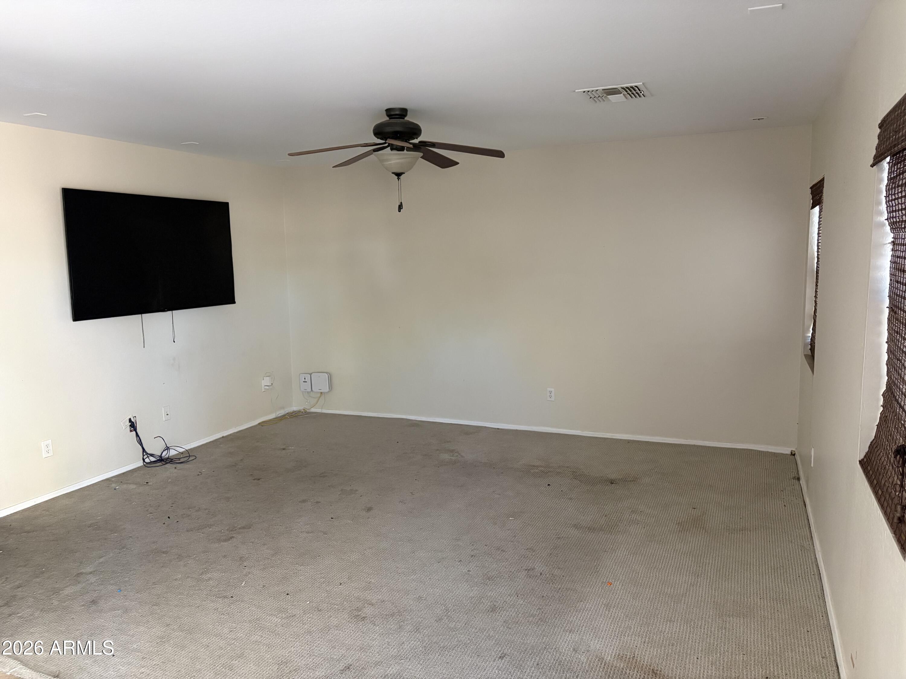 5222 East Silverbell Road San Tan Valley, AZ 85143 - Photo 6 of 16 an empty room with a flat screen tv