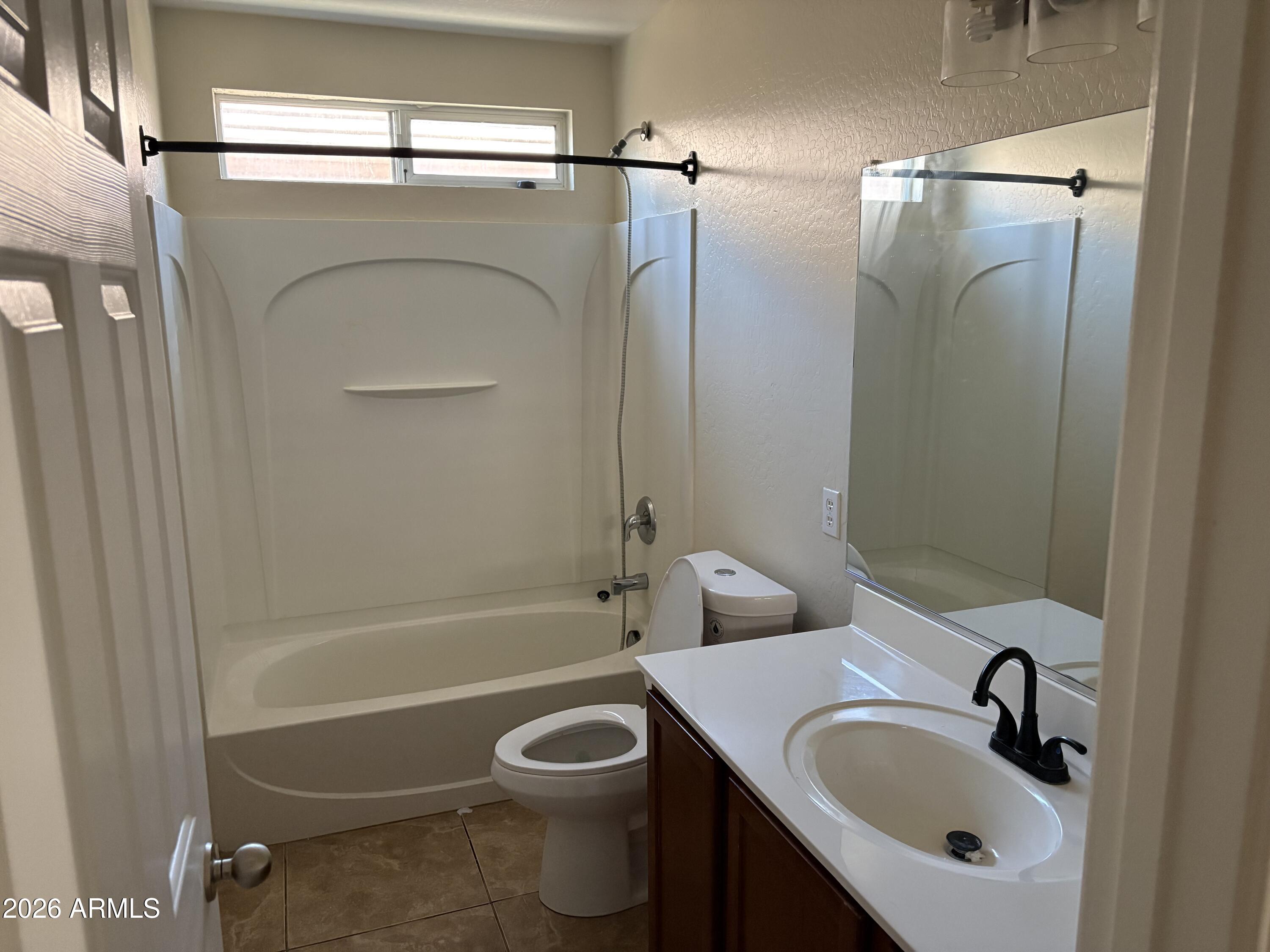 5222 East Silverbell Road San Tan Valley, AZ 85143 - Photo 7 of 16 a bathroom with a sink toilet and shower