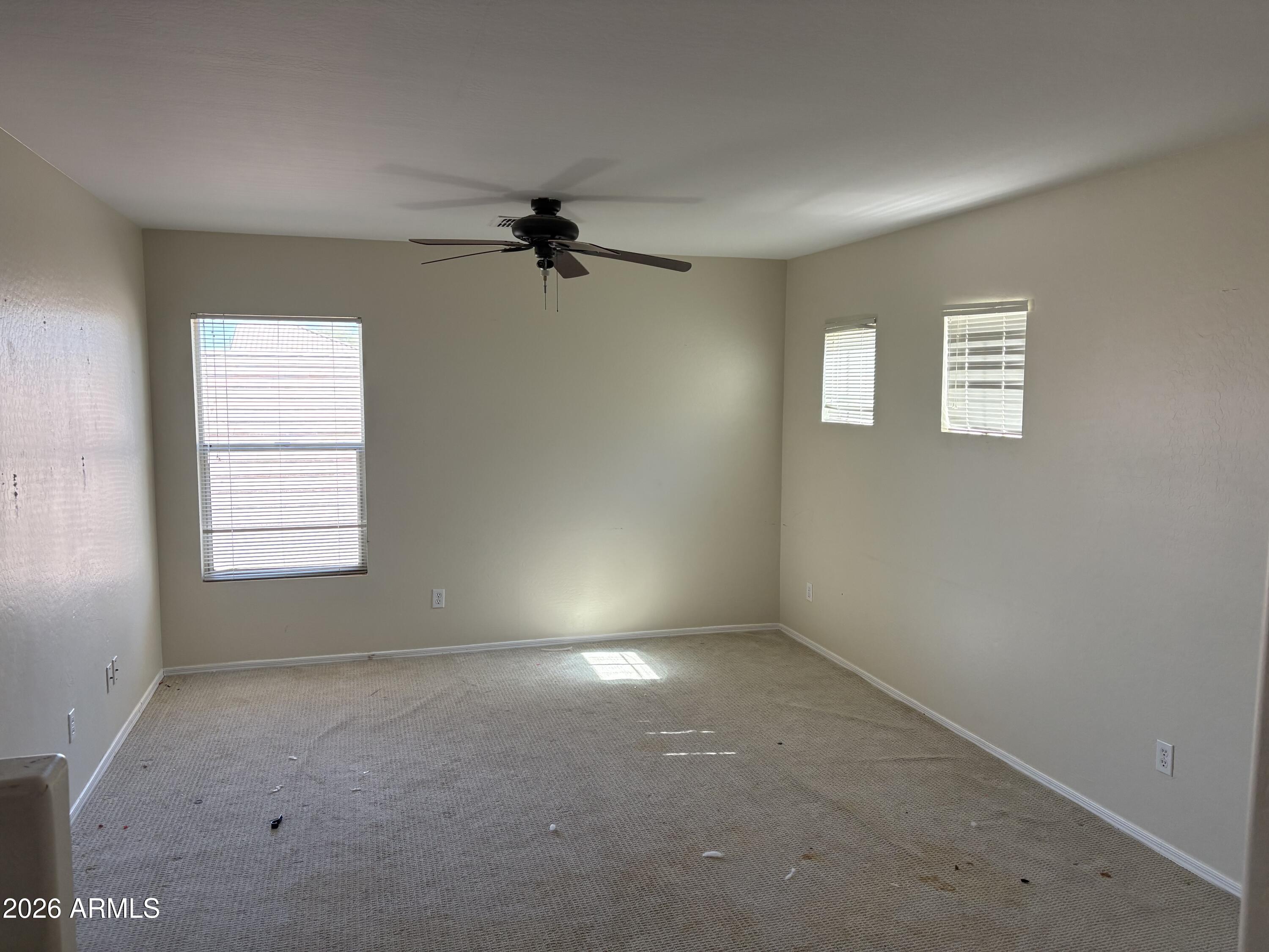 5222 East Silverbell Road San Tan Valley, AZ 85143 - Photo 10 of 16 an empty room with windows and fan