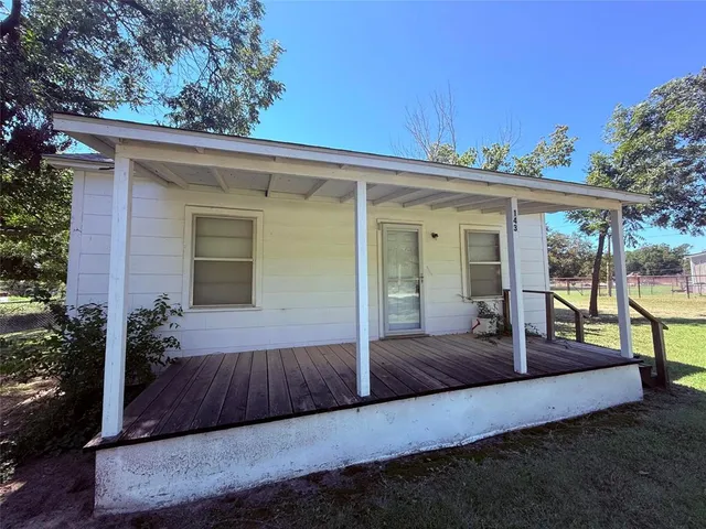 a view of a porch with furniture and garden