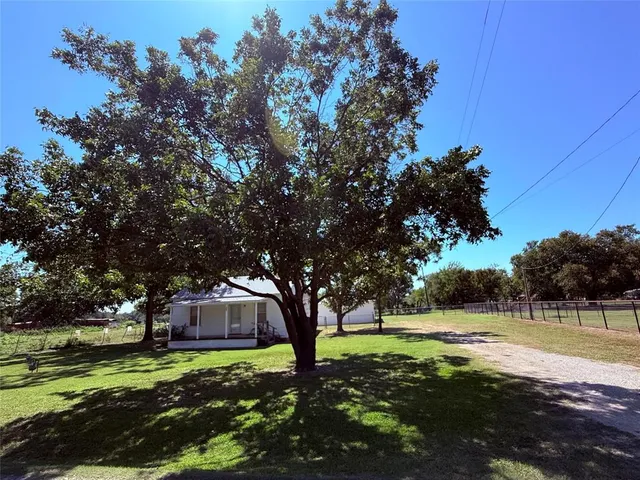 a backyard of a house with lots of green space