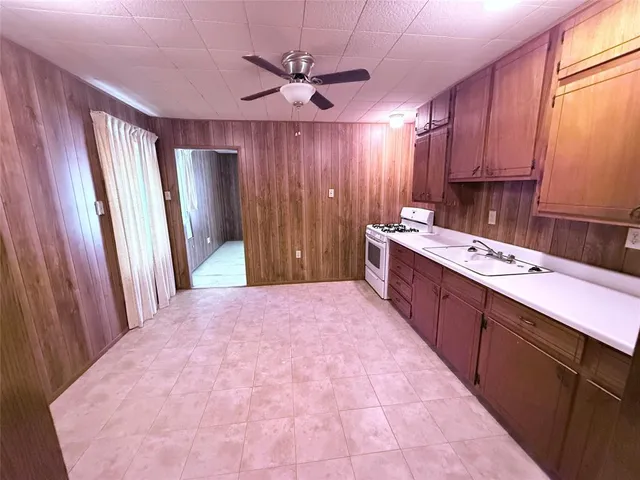 a kitchen with a sink cabinets and window