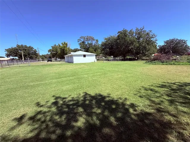 a view of a field with an trees