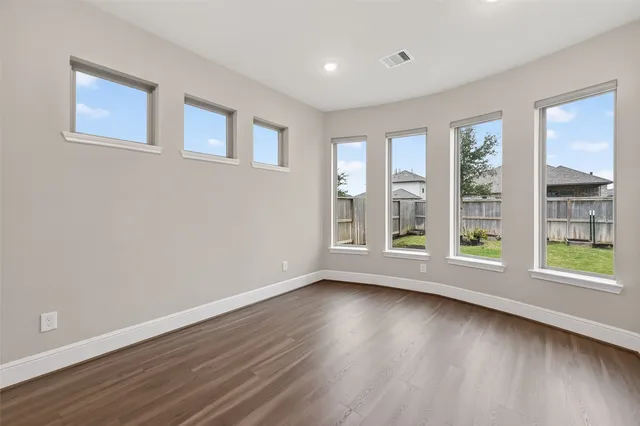 a view of room with window and hardwood floor