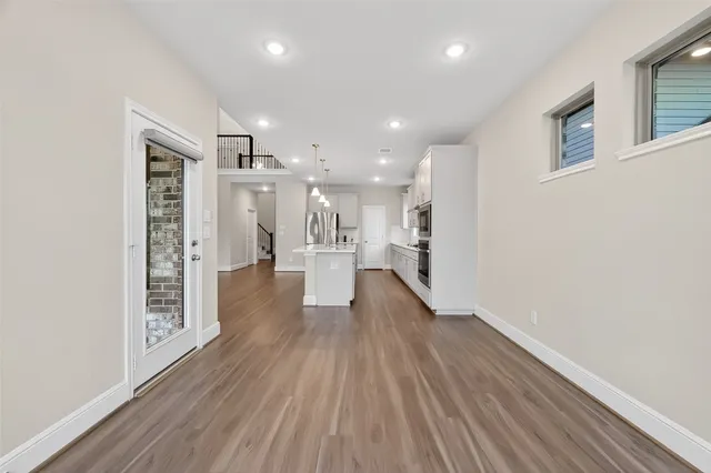 a view of a hallway with wooden floor