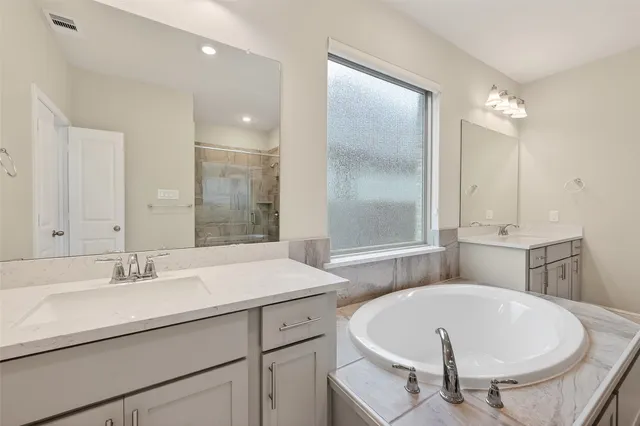 a bathroom with a bathtub and a sink