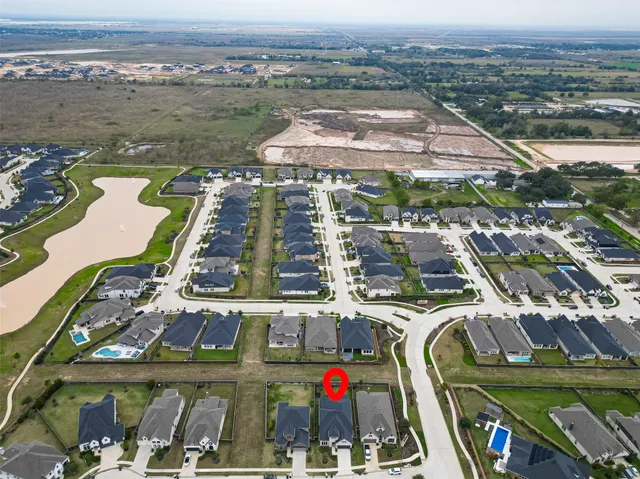 an aerial view of residential houses with outdoor space